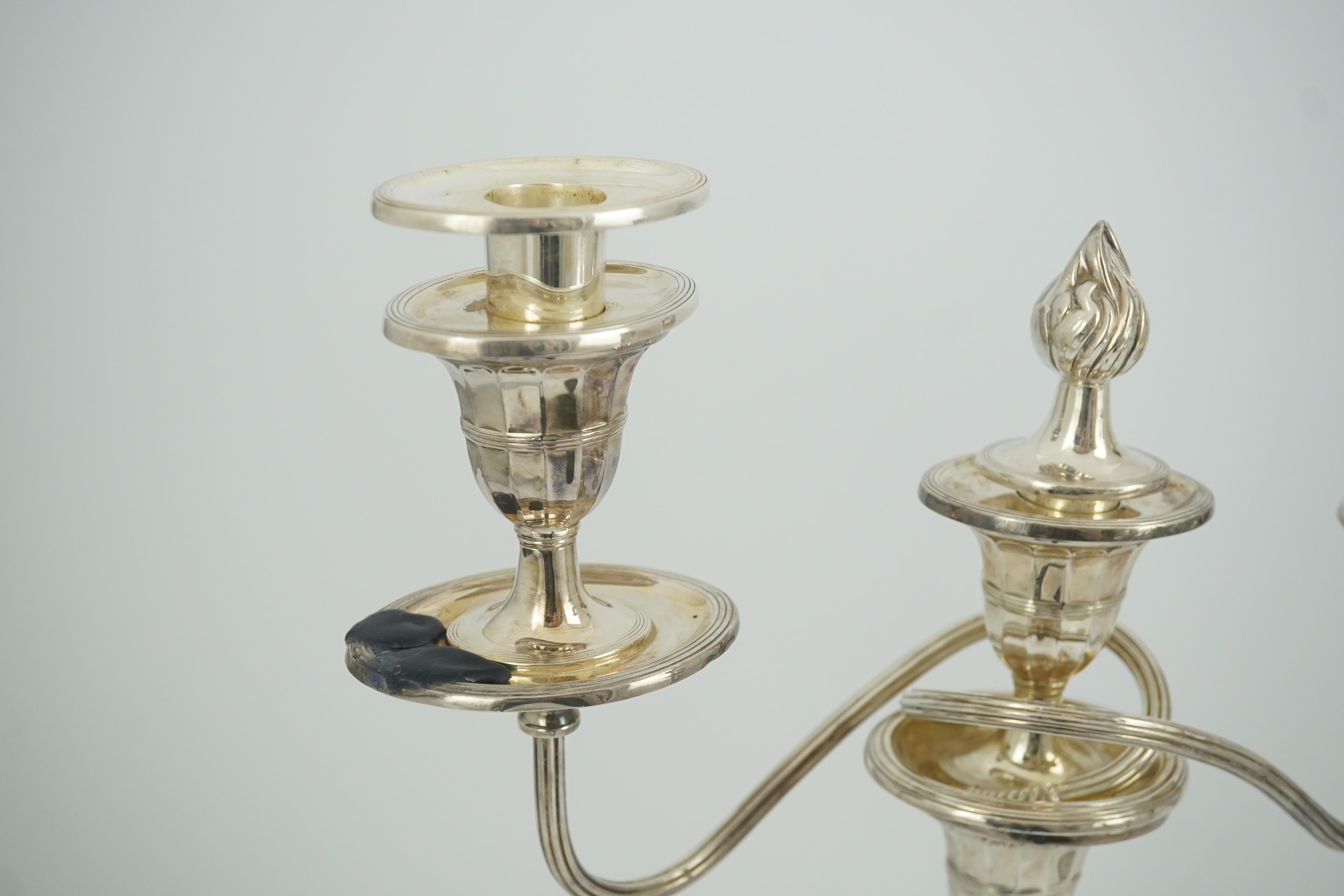 A modern pair of silver two branch three light oval candelabra, by James Dixon and Sons Ltd